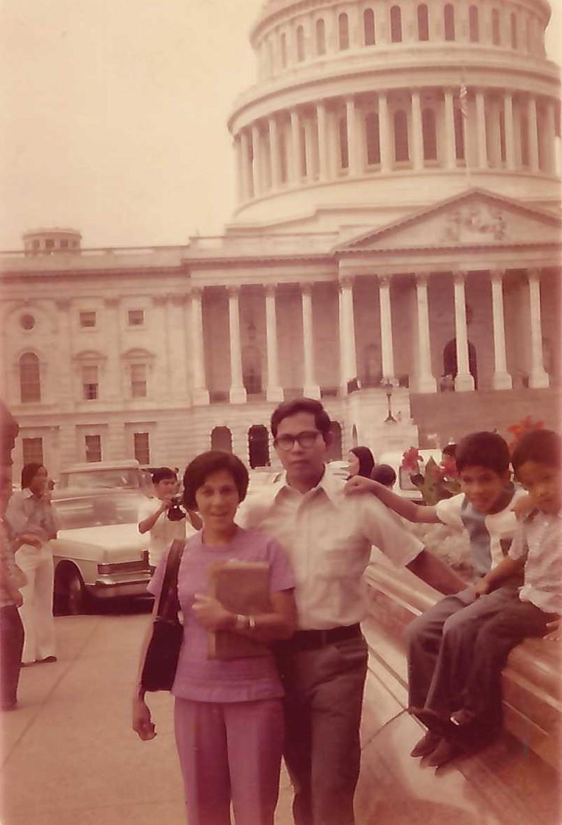 A family poses outside a prominent government building, enjoying a sunny day in Washington D.C.
