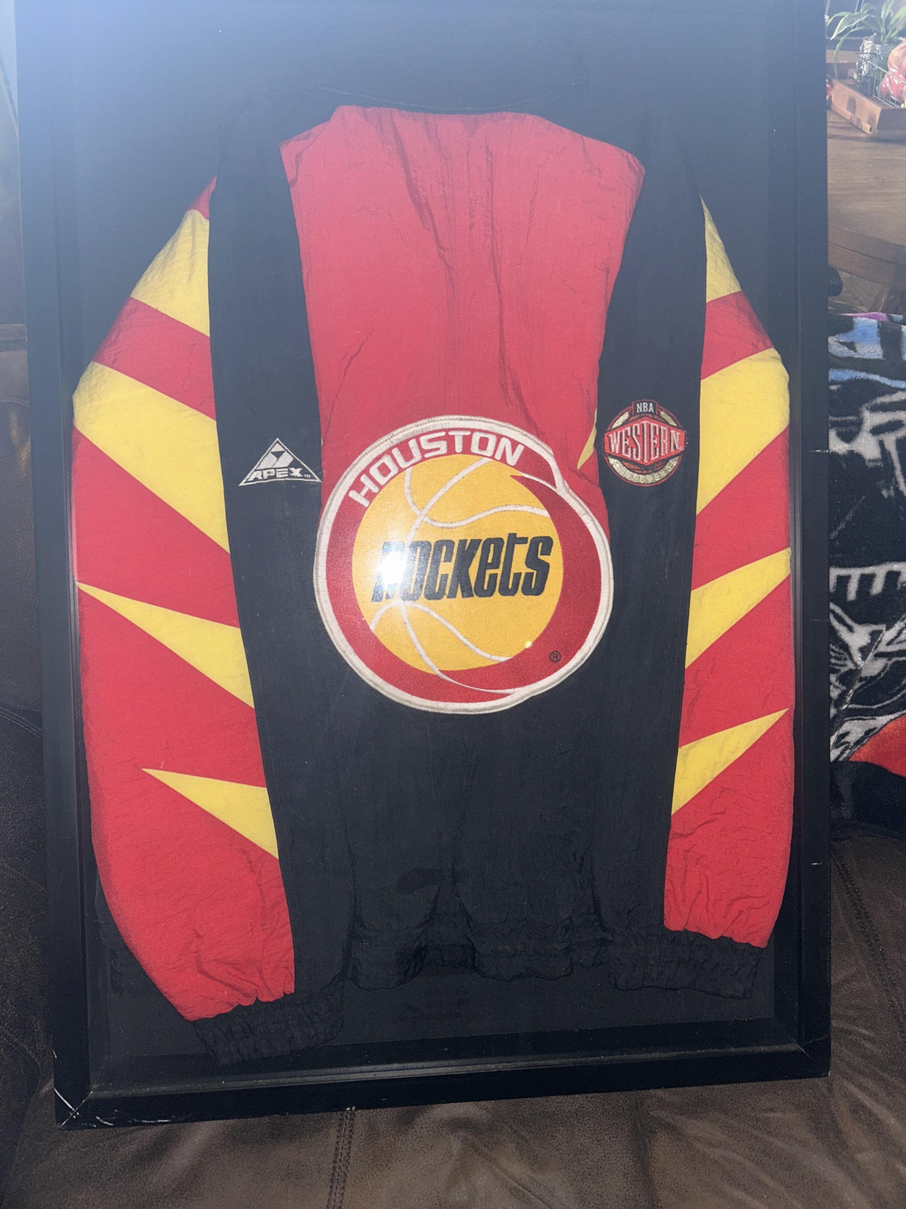 A brightly colored Houston Rockets jersey hangs in a store, catching basketball fans' eyes.