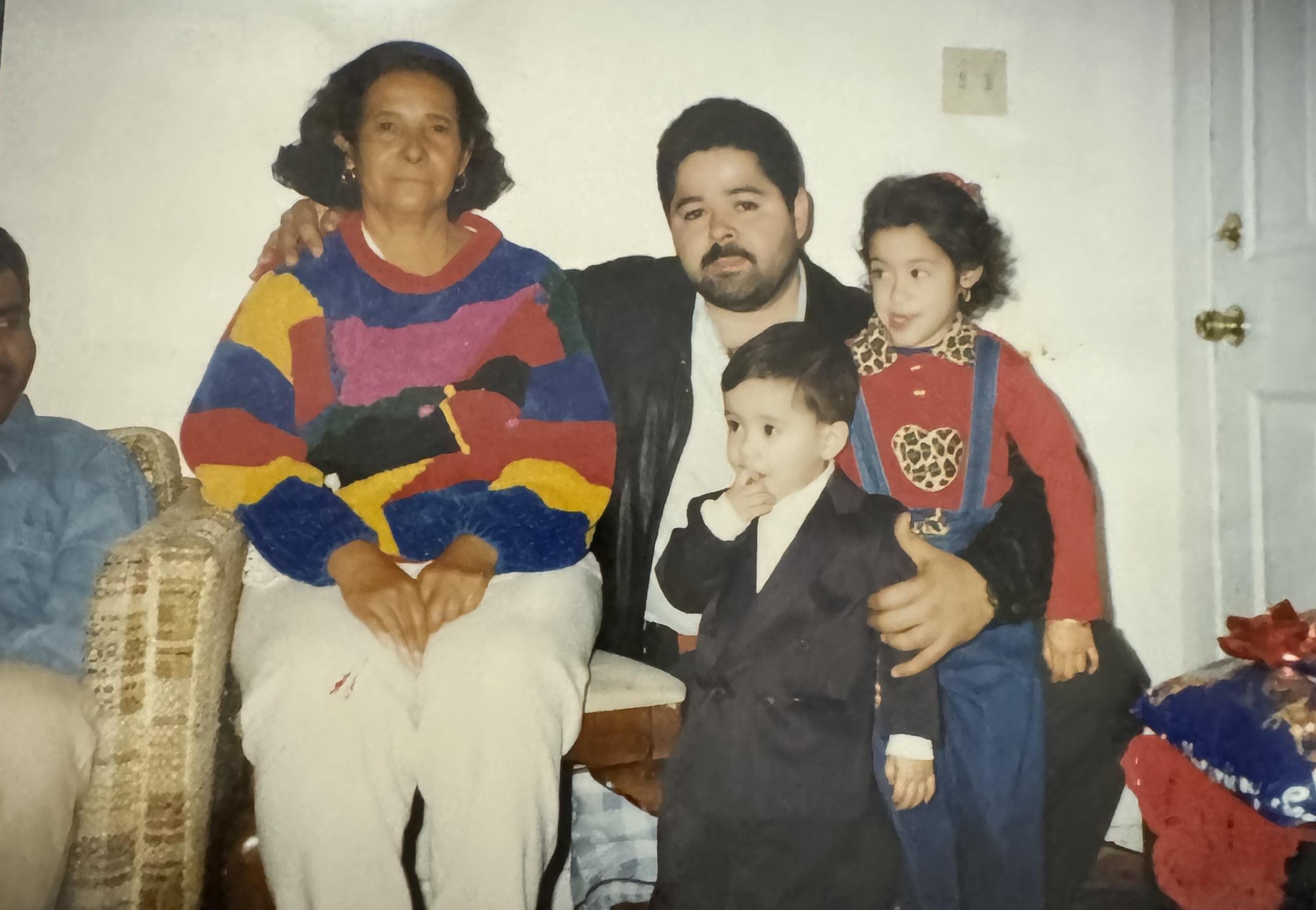 A family shares a joyful moment in their living room, filled with laughter and colorful clothes.