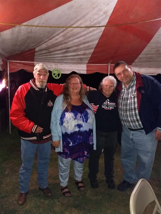 A group of people standing in front of a tent