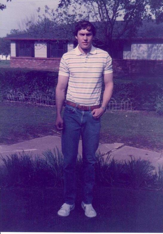 A man standing outside in a yard