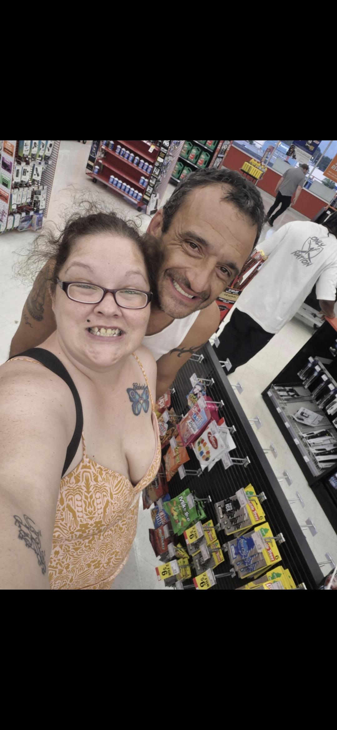 Two friends share a joyful moment while exploring a vibrant store aisle filled with products.