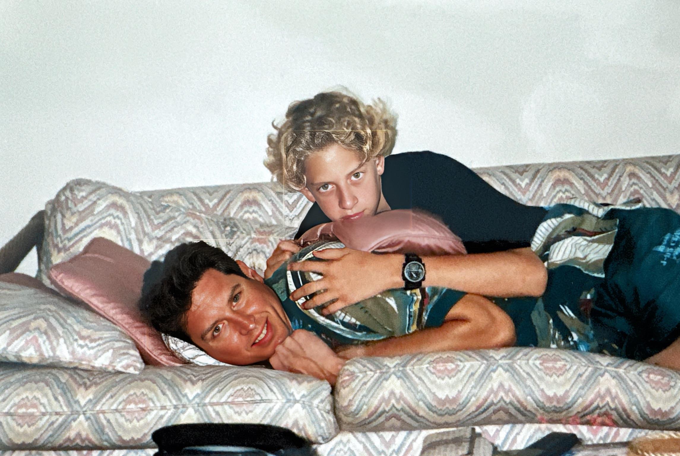 Friends share a lighthearted moment on a couch, showcasing friendship and relaxation at home.