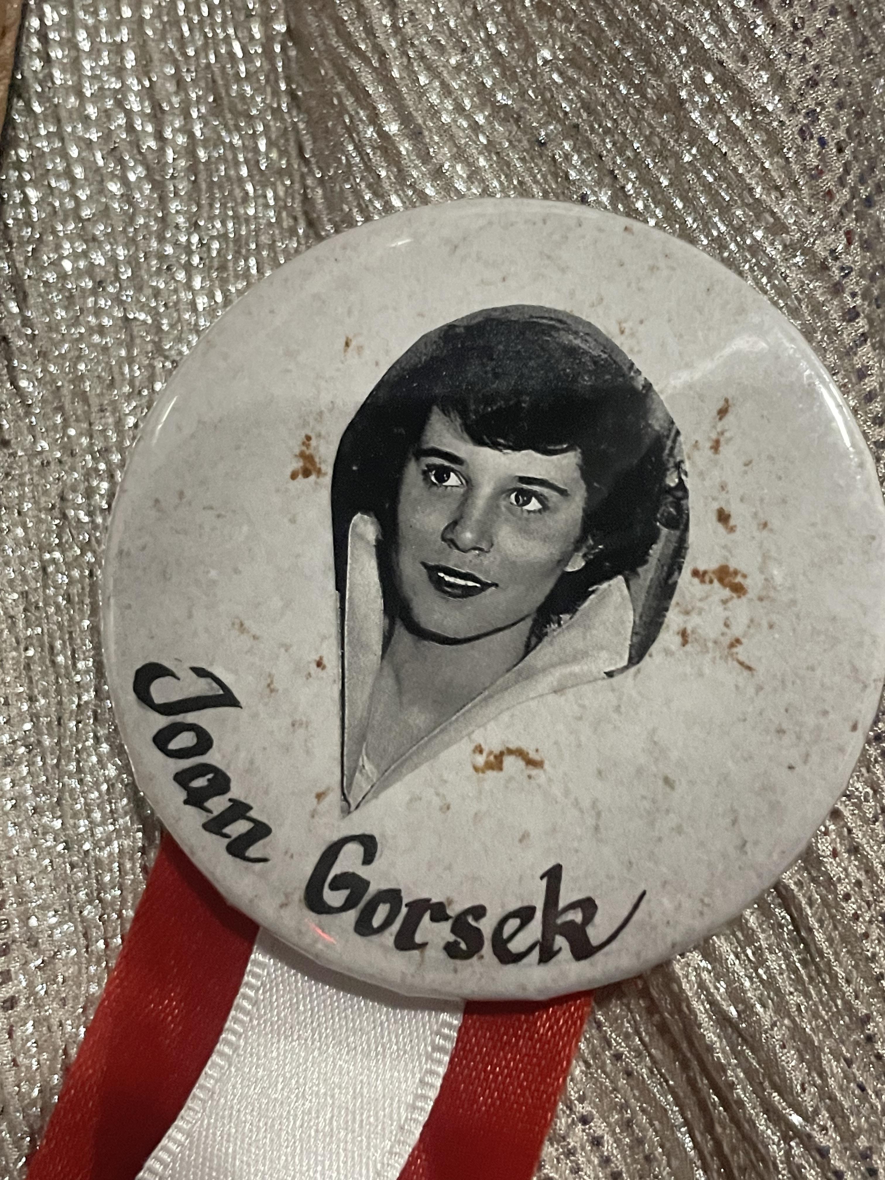 Vintage button showcases a black and white image of Joan Gorsek with a glossy finish.