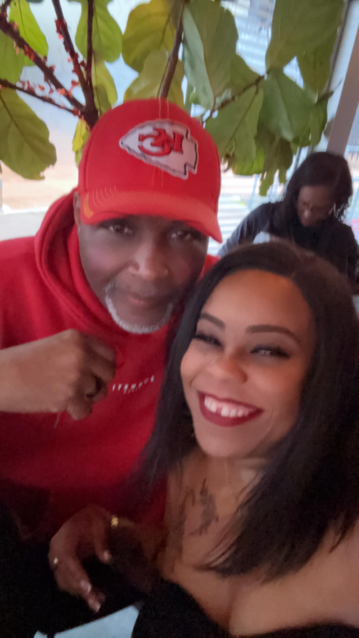 Two friends enjoying a cheerful moment together with smiles and laughter in a cozy café setting.