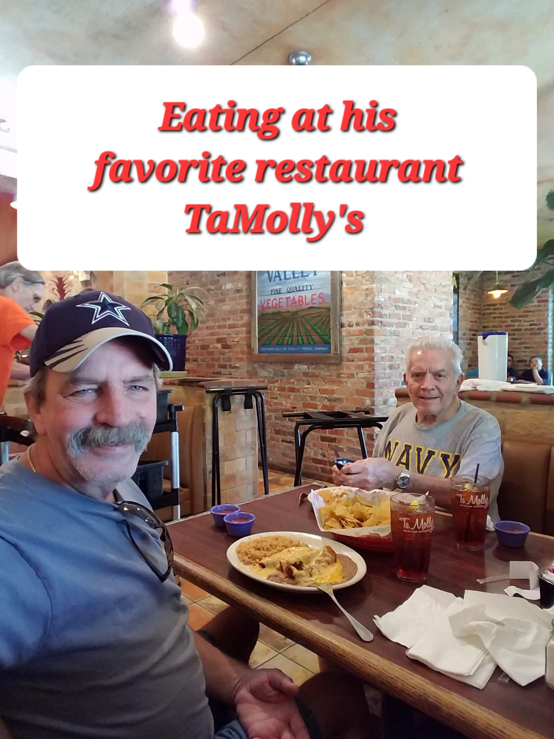 Two men sit at a table, sharing a meal at a favorite restaurant on a bright day.