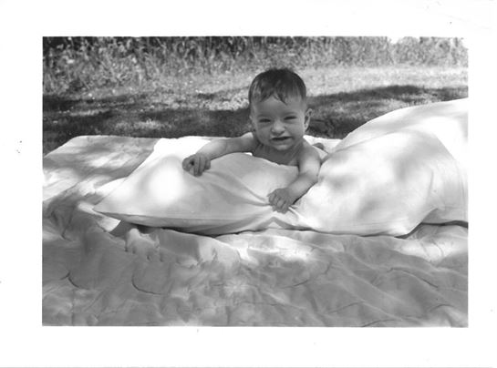 A baby lying on a blanket