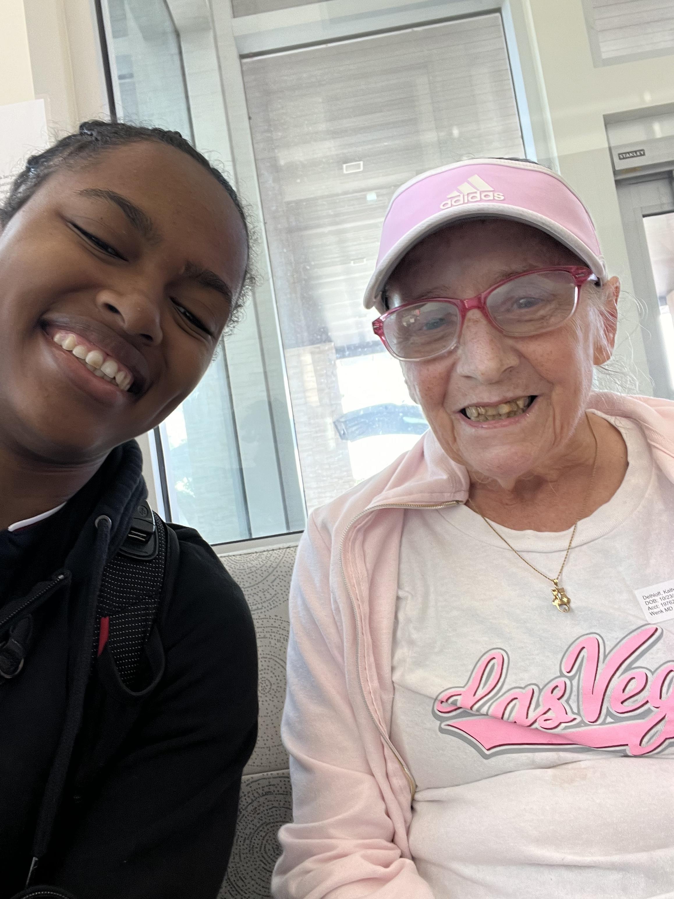 A joyful moment shared between a young woman and an elderly lady at the airport in Las Vegas.