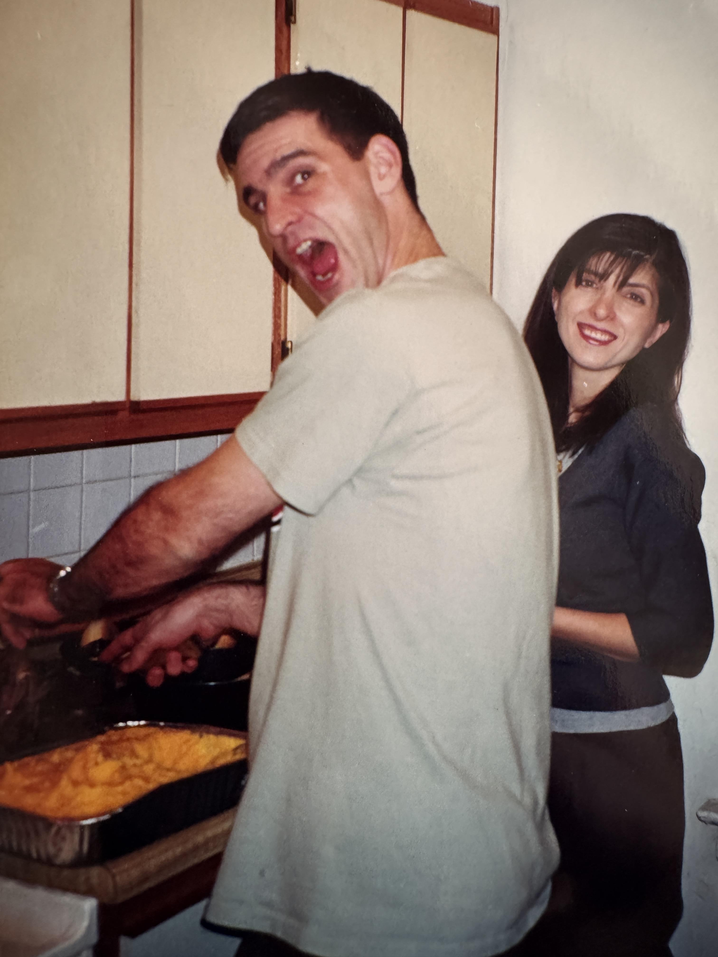 A man and woman cooking in a kitchen