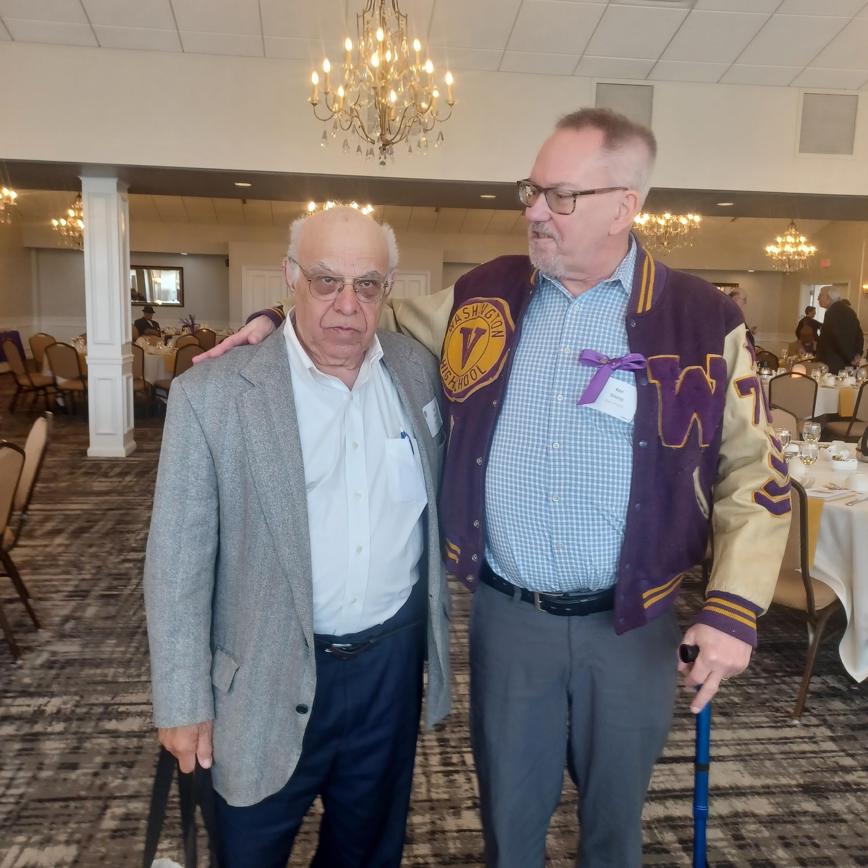 Two men standing together in a room