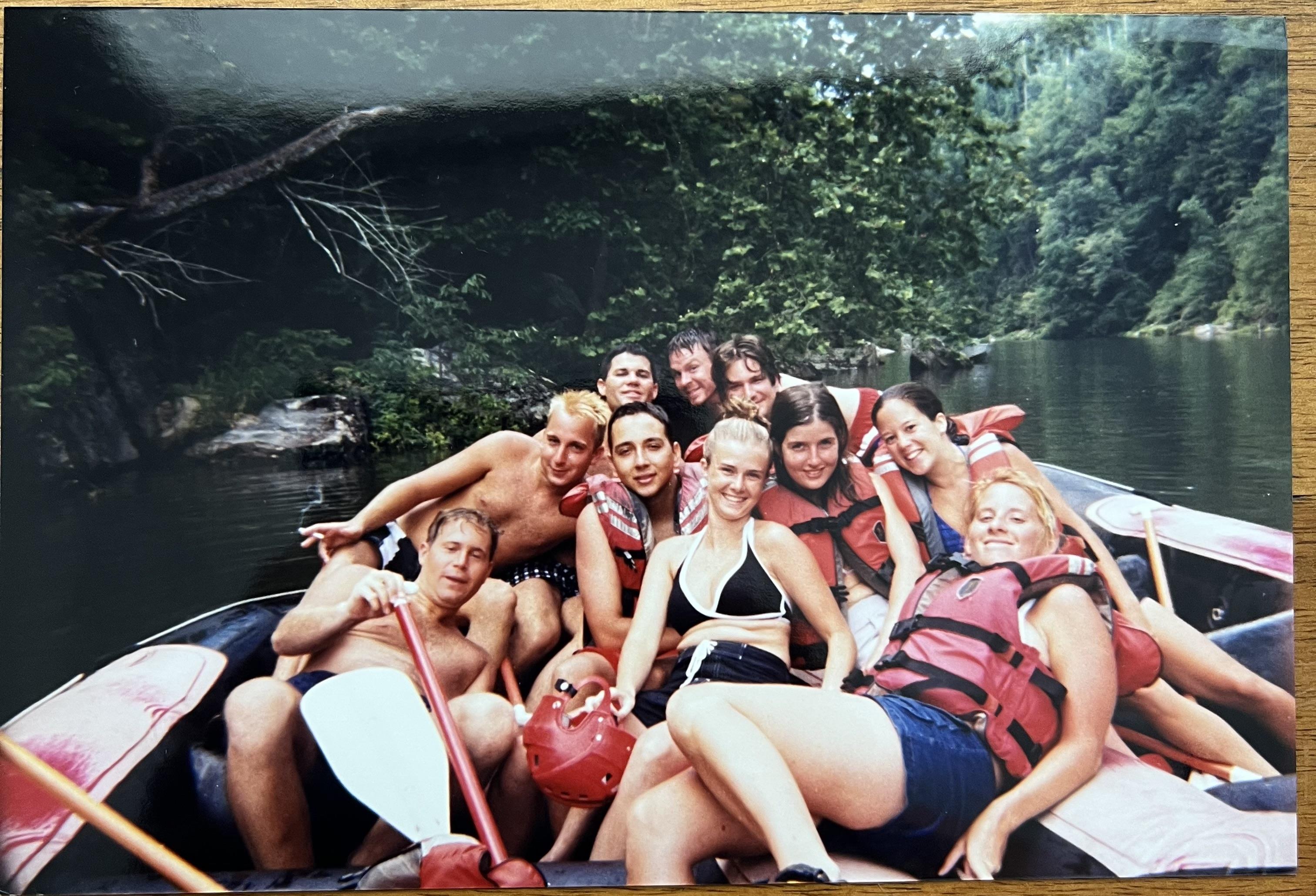 Participants are smiling and posing together in a boat while enjoying their adventure on the river.