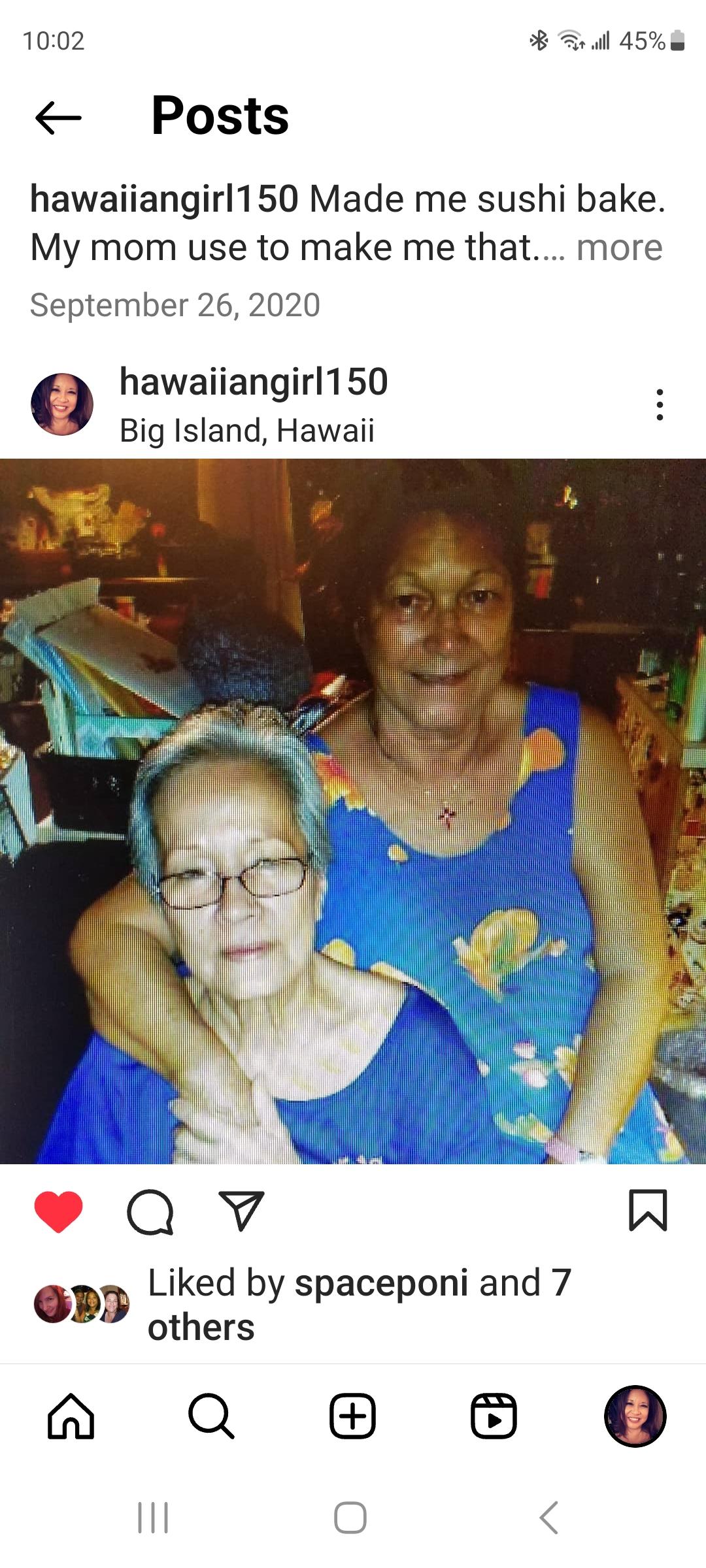 Two women share a moment of affection, showcasing their bond in a welcoming Hawaiian home.