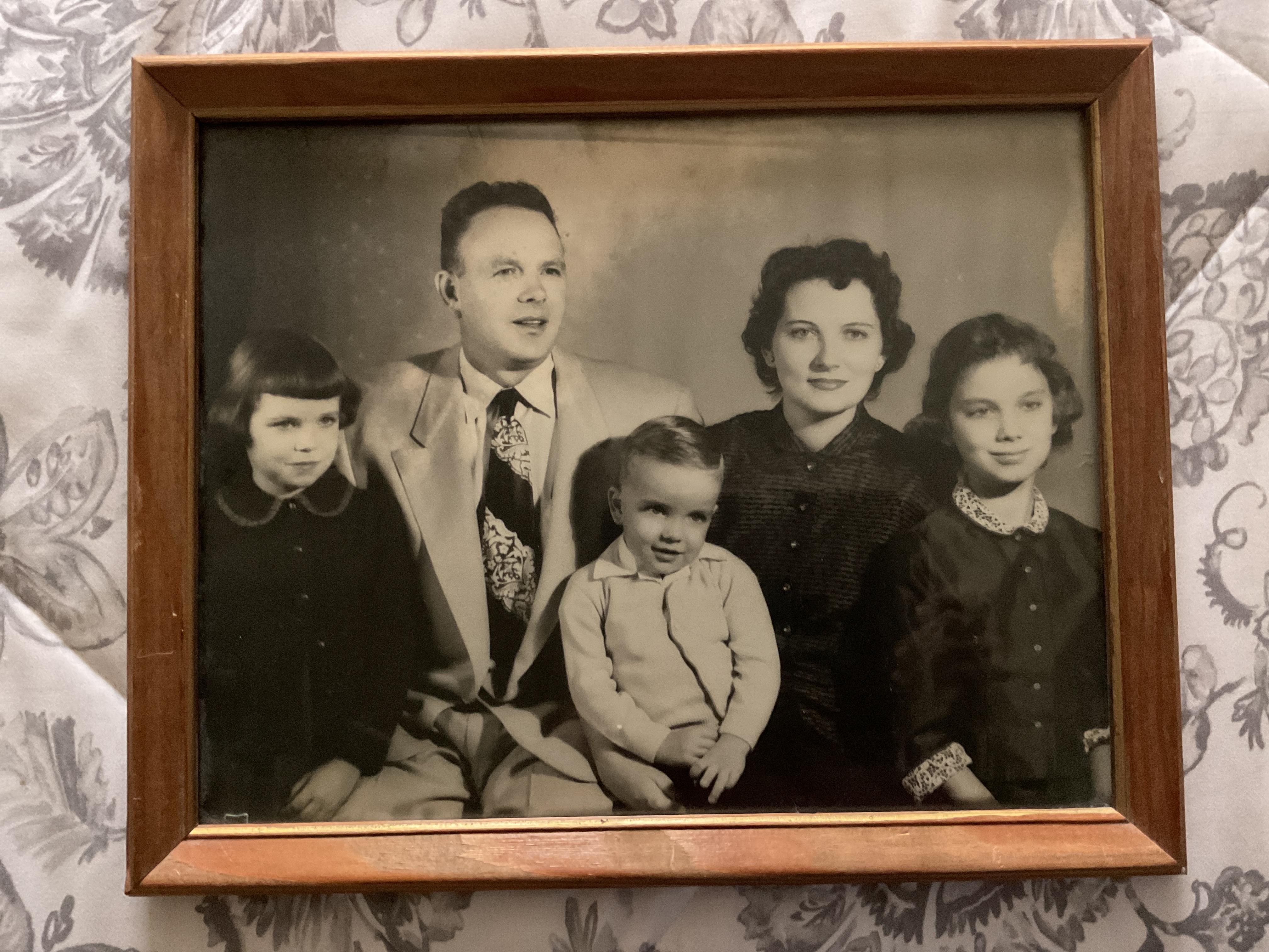 Group of five family members pose together, showcasing clothing styles from the 1950s.