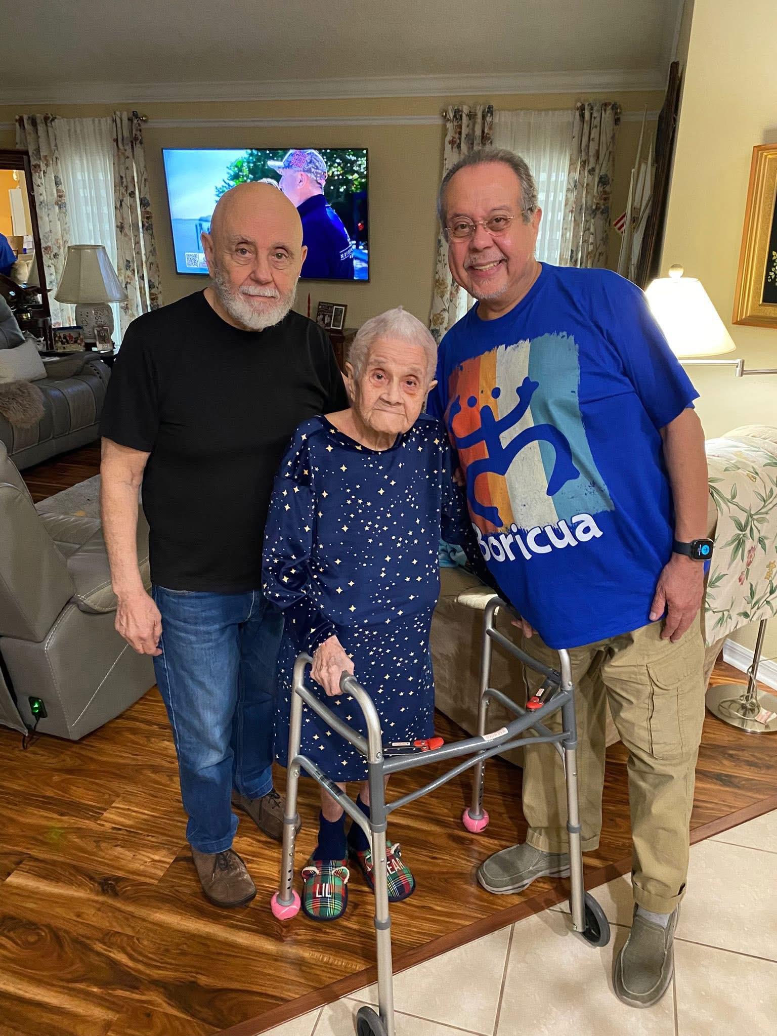 Family members celebrate a joyful moment in their living room, sharing smiles and love together.