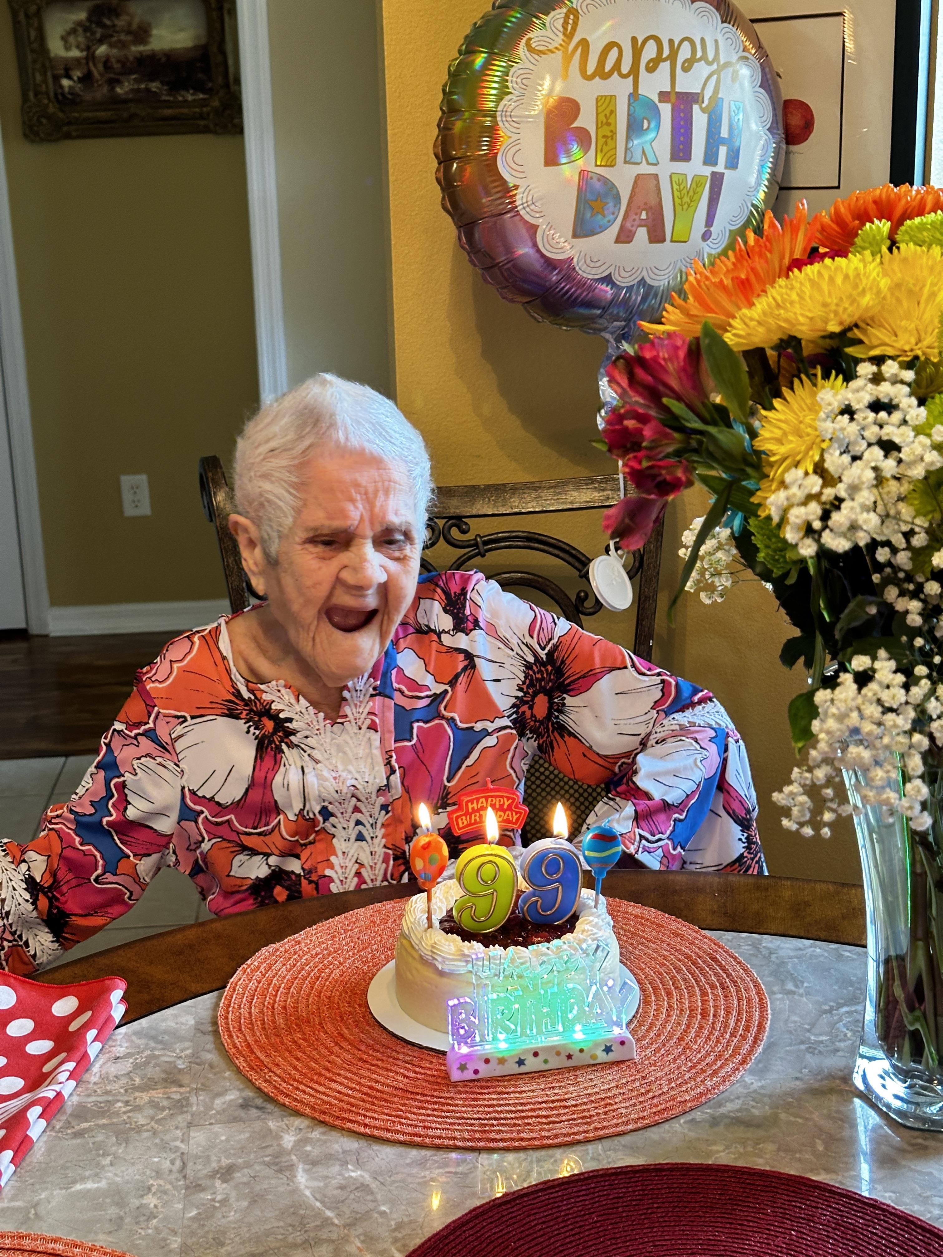 Grandma celebrates her birthday with a colorful cake, happy faces, and loved ones around.