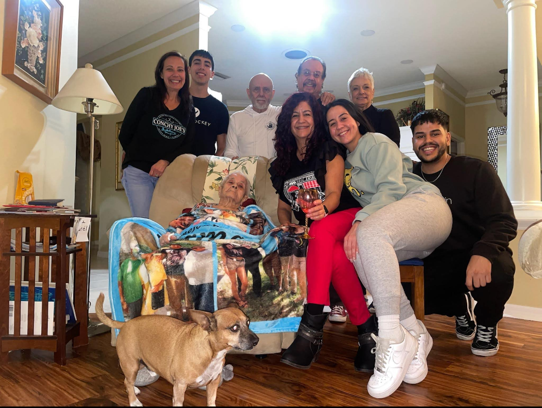 Family and friends come together to celebrate and enjoy each other's company in a warm setting.