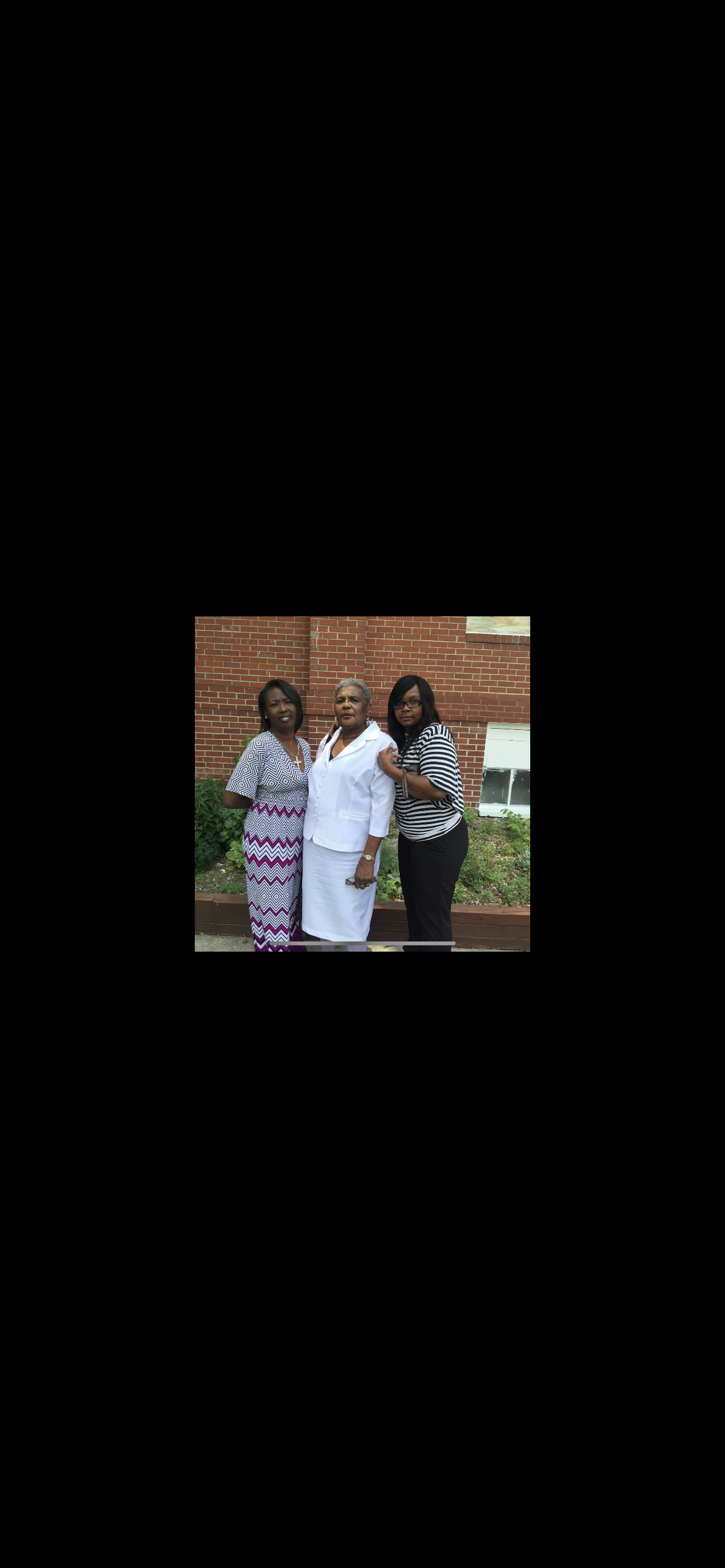 Three women share a joyful moment outdoors, showcasing their family connection in summer attire.
