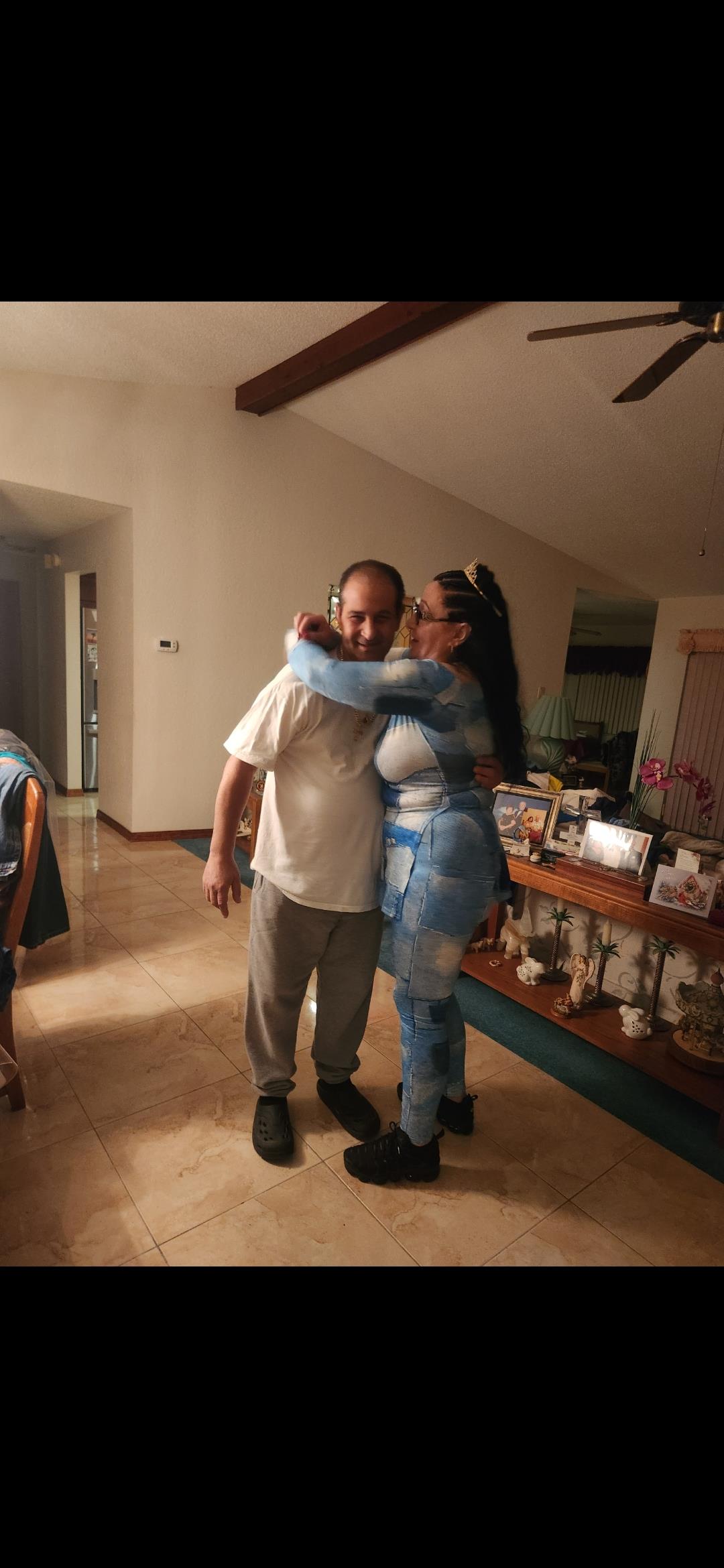 A man and woman hugging in a room