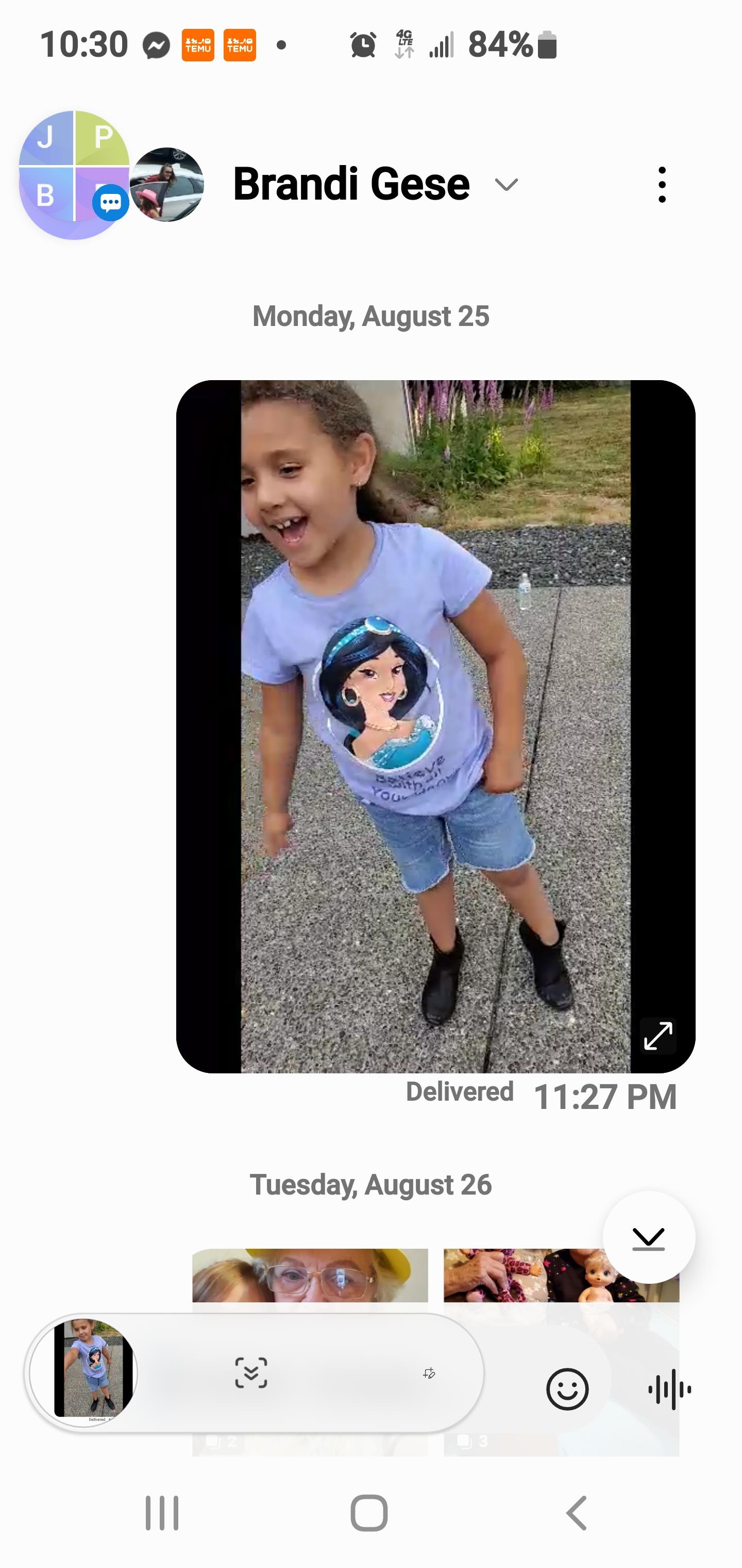 Child plays outside, wearing a casual outfit with a cheerful expression on her face.