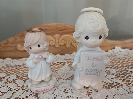 Two figurines of angels on a table