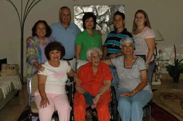 A lively family gathering with elderly and younger members enjoying each other's company.