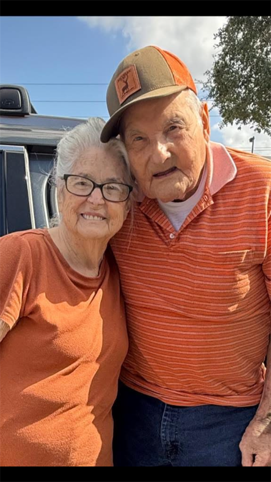 A man and woman posing for a picture