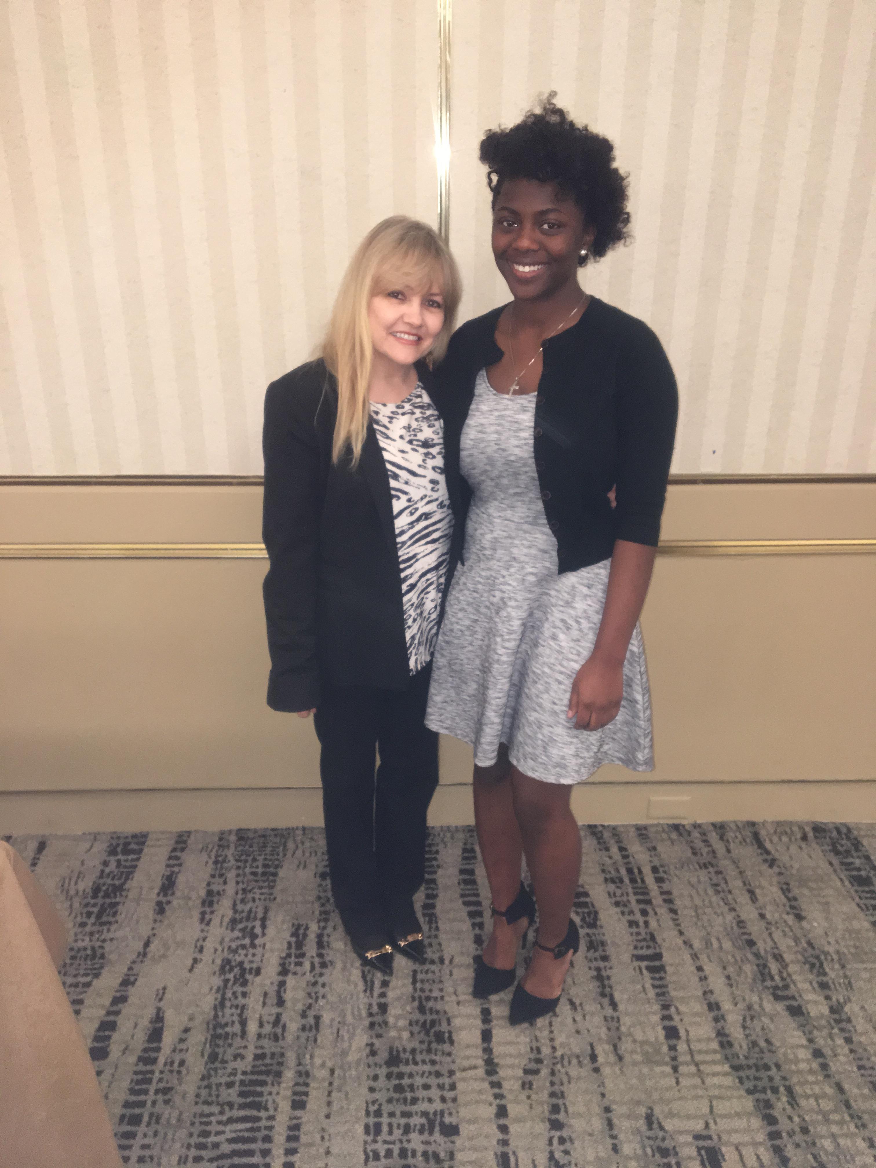 Two women standing together smiling
