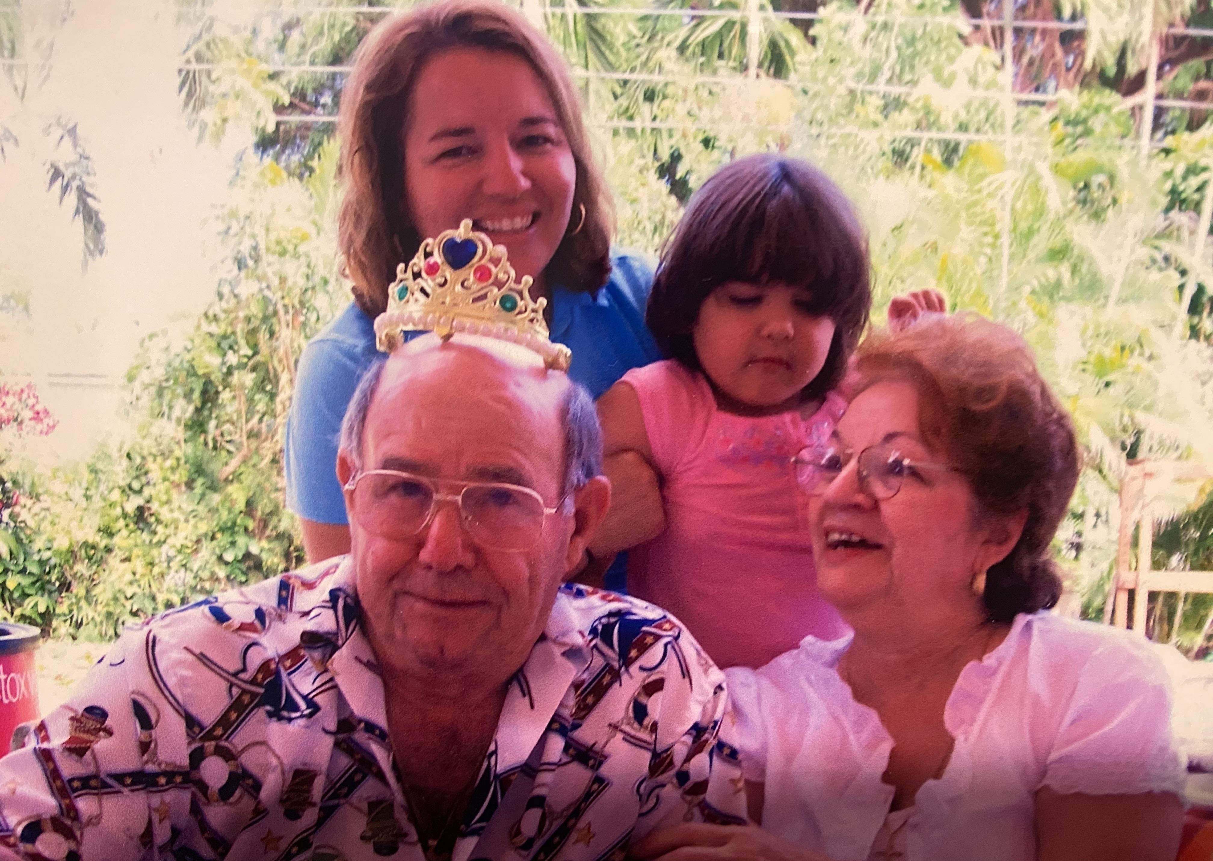 A family gathers in a garden, sharing laughter and joy, celebrating a special milestone together.