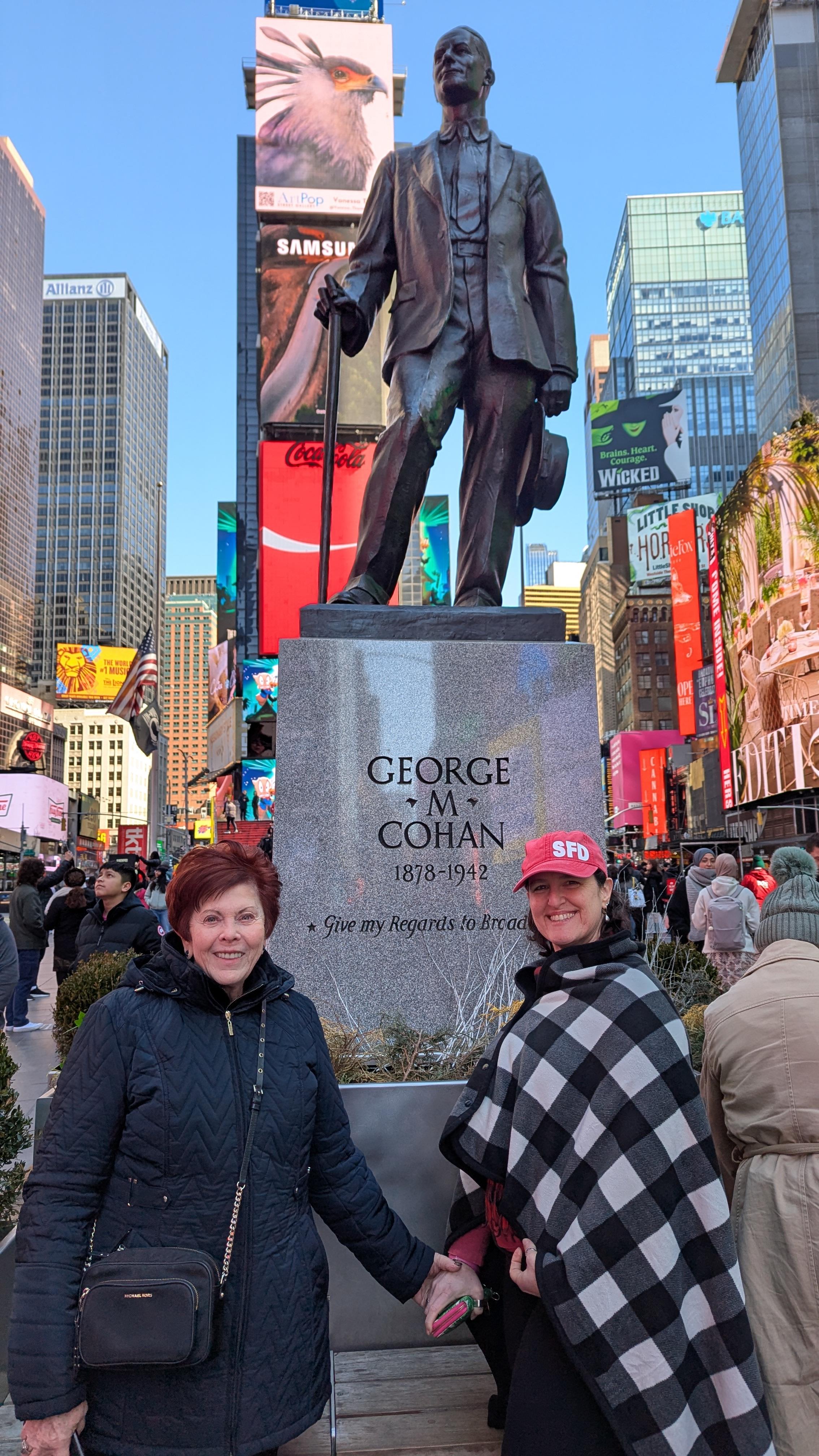 Two women stand by the George M.