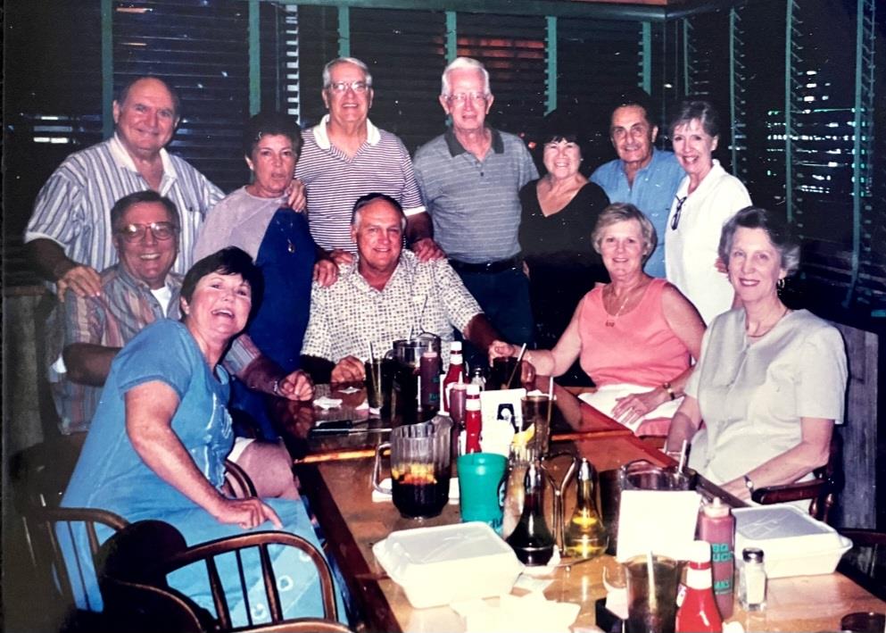 A lively group of friends enjoys a dinner together at a restaurant, sharing laughter and stories.