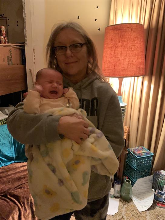 A woman holding a crying baby