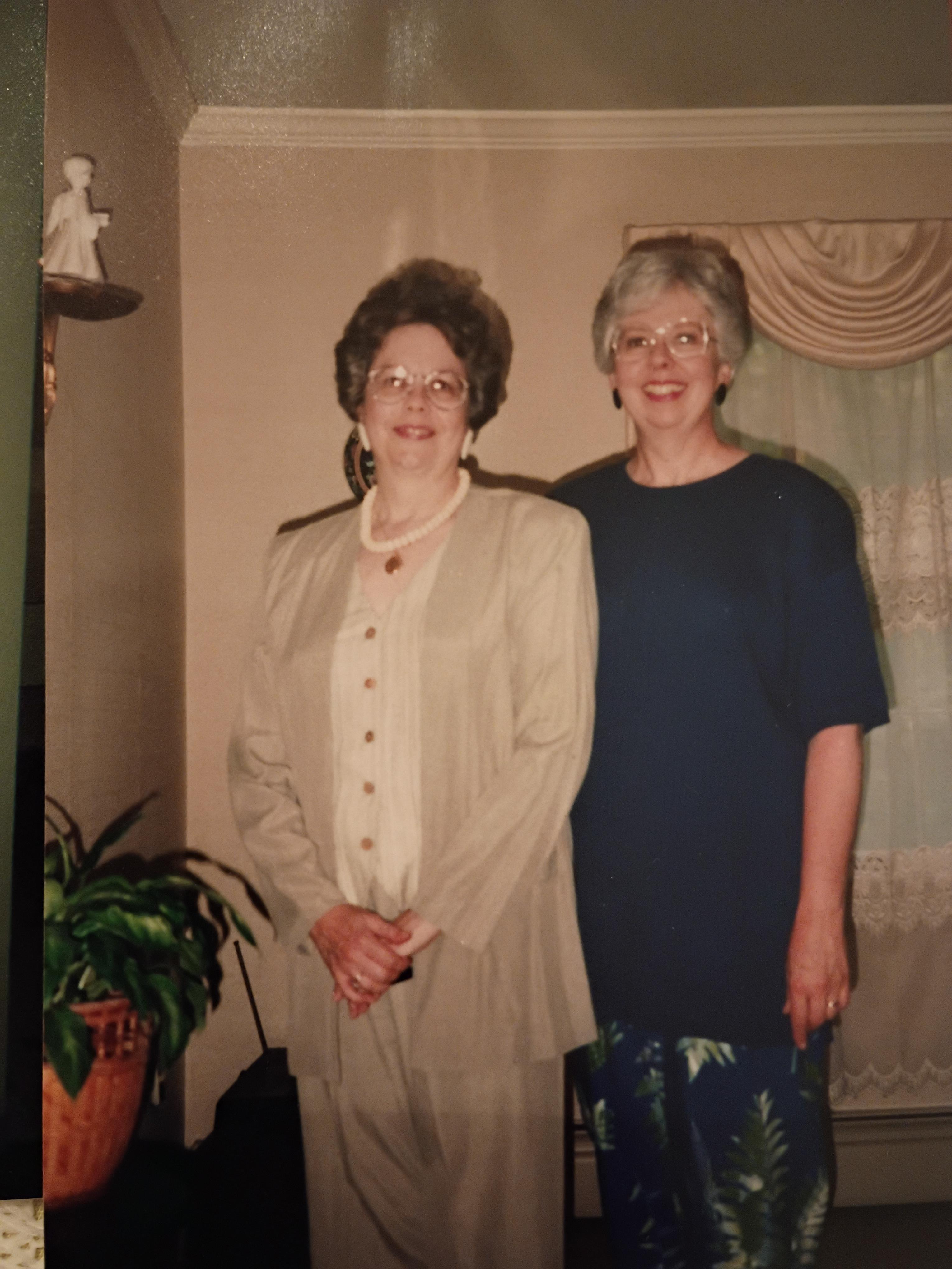 Two women standing together smiling