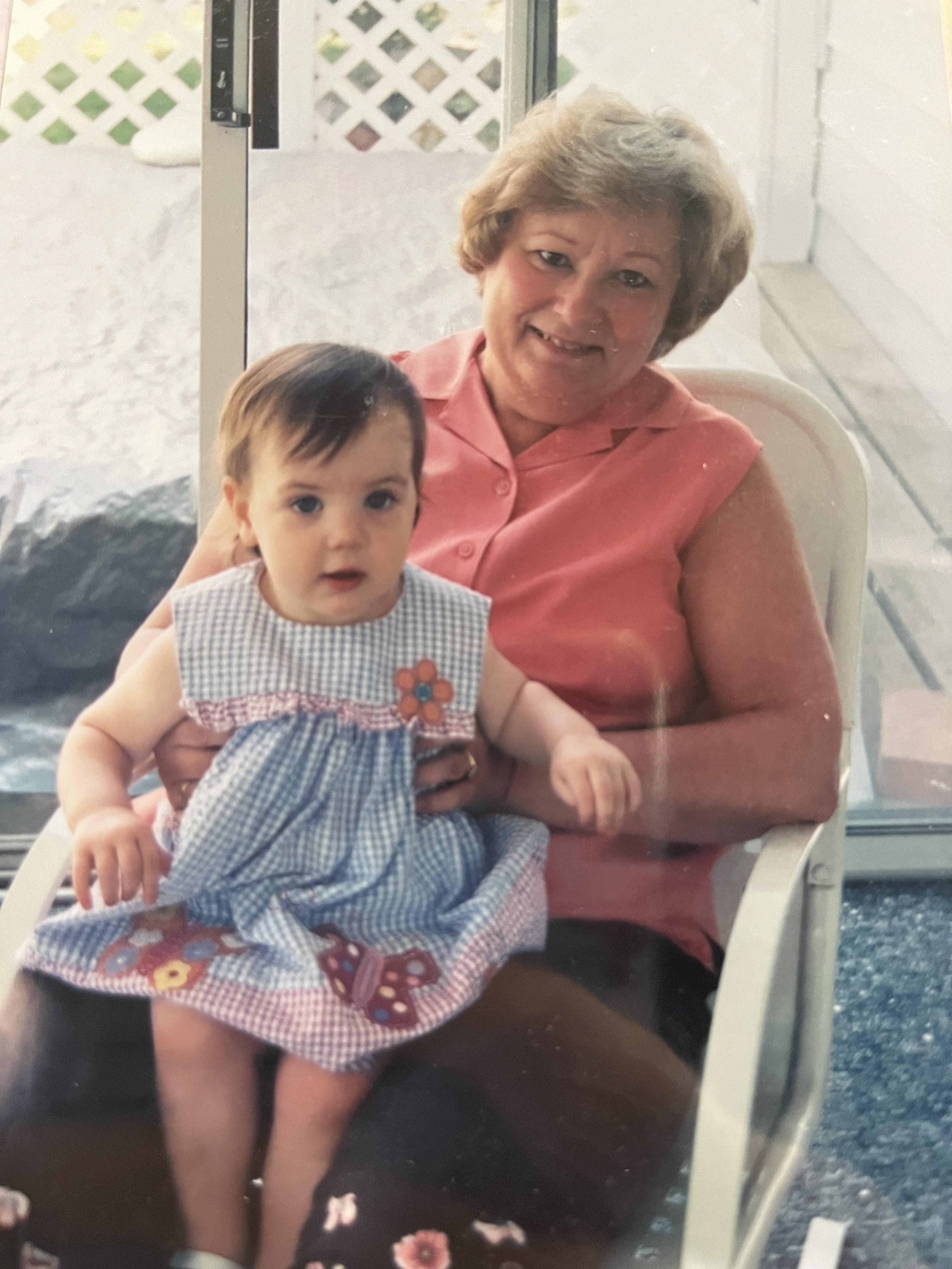 Grandmother and granddaughter share a joyful moment indoors, enjoying each other's company.