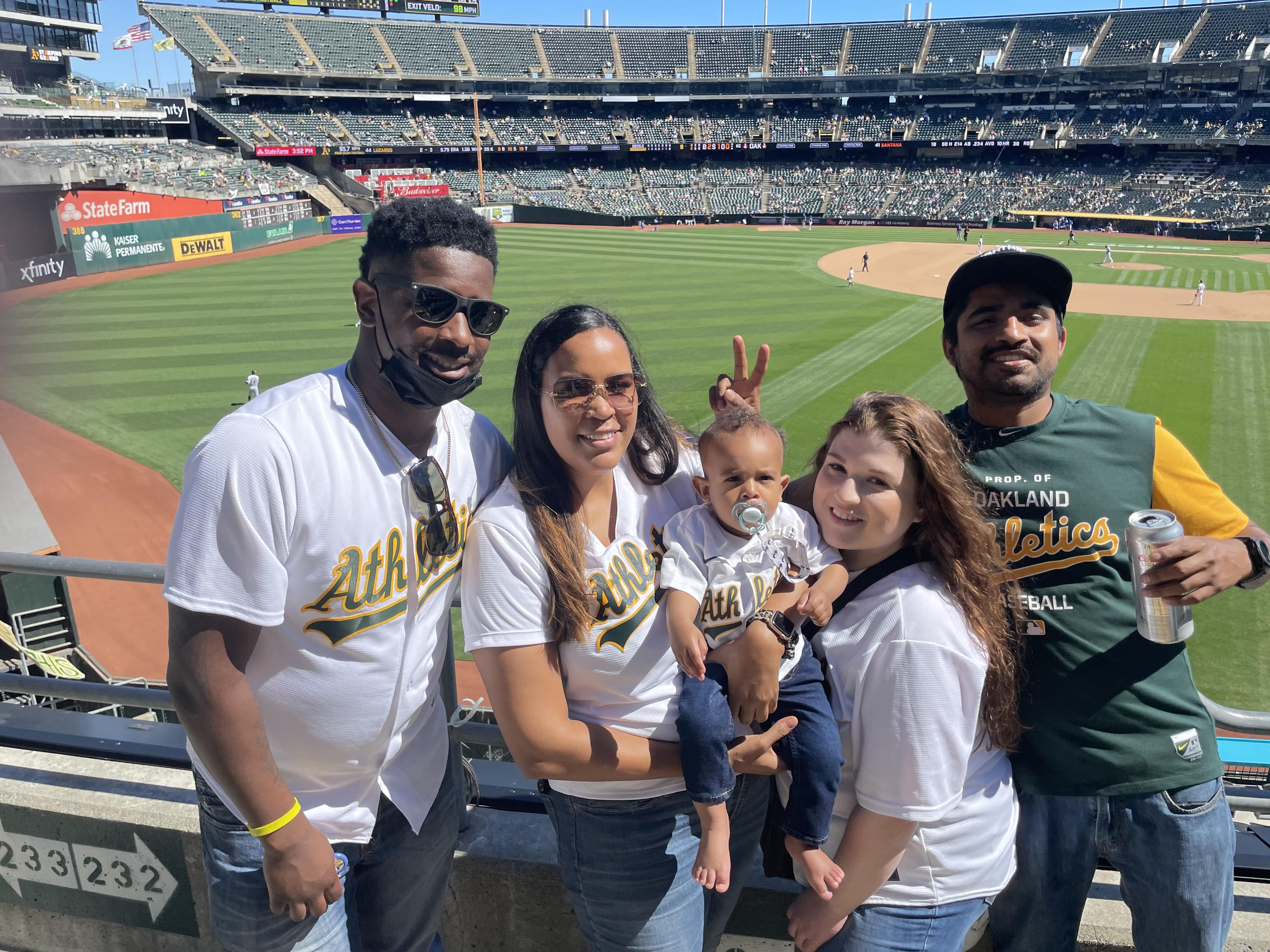Group of friends and family gather to celebrate a game day at the baseball stadium.