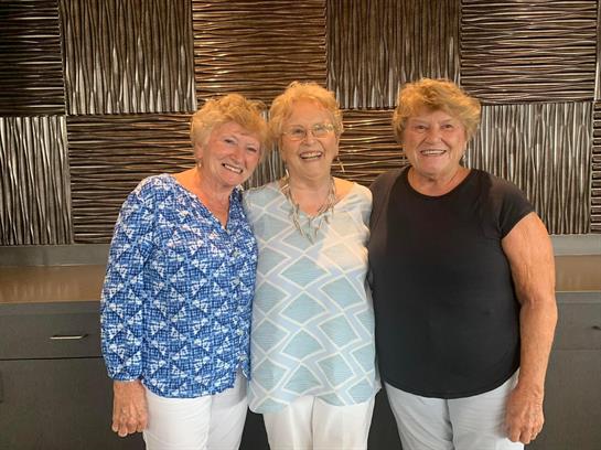 A group of women standing together smiling