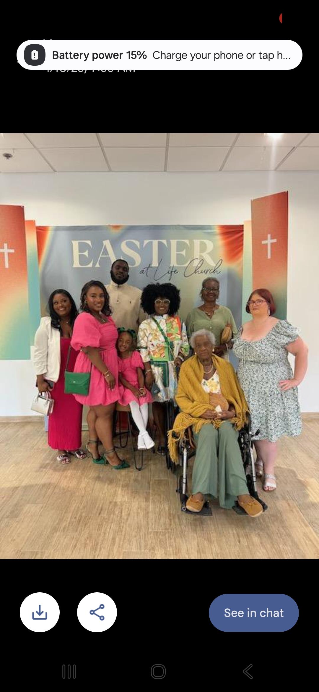 A joyful family gathers to celebrate Easter together at a church event with colorful decorations.