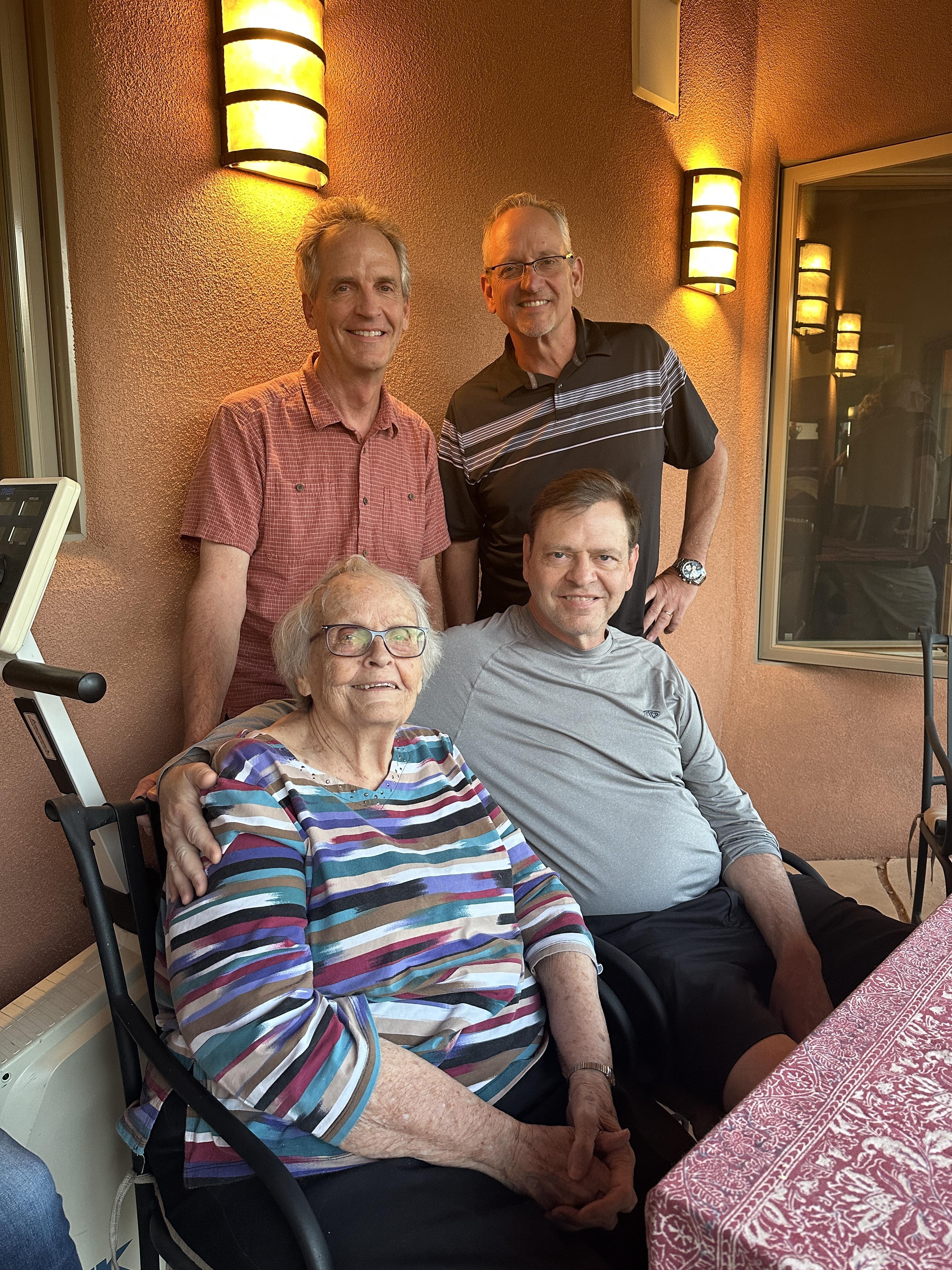 Four relatives share a lighthearted moment outdoors, with warmth and camaraderie evident among them.