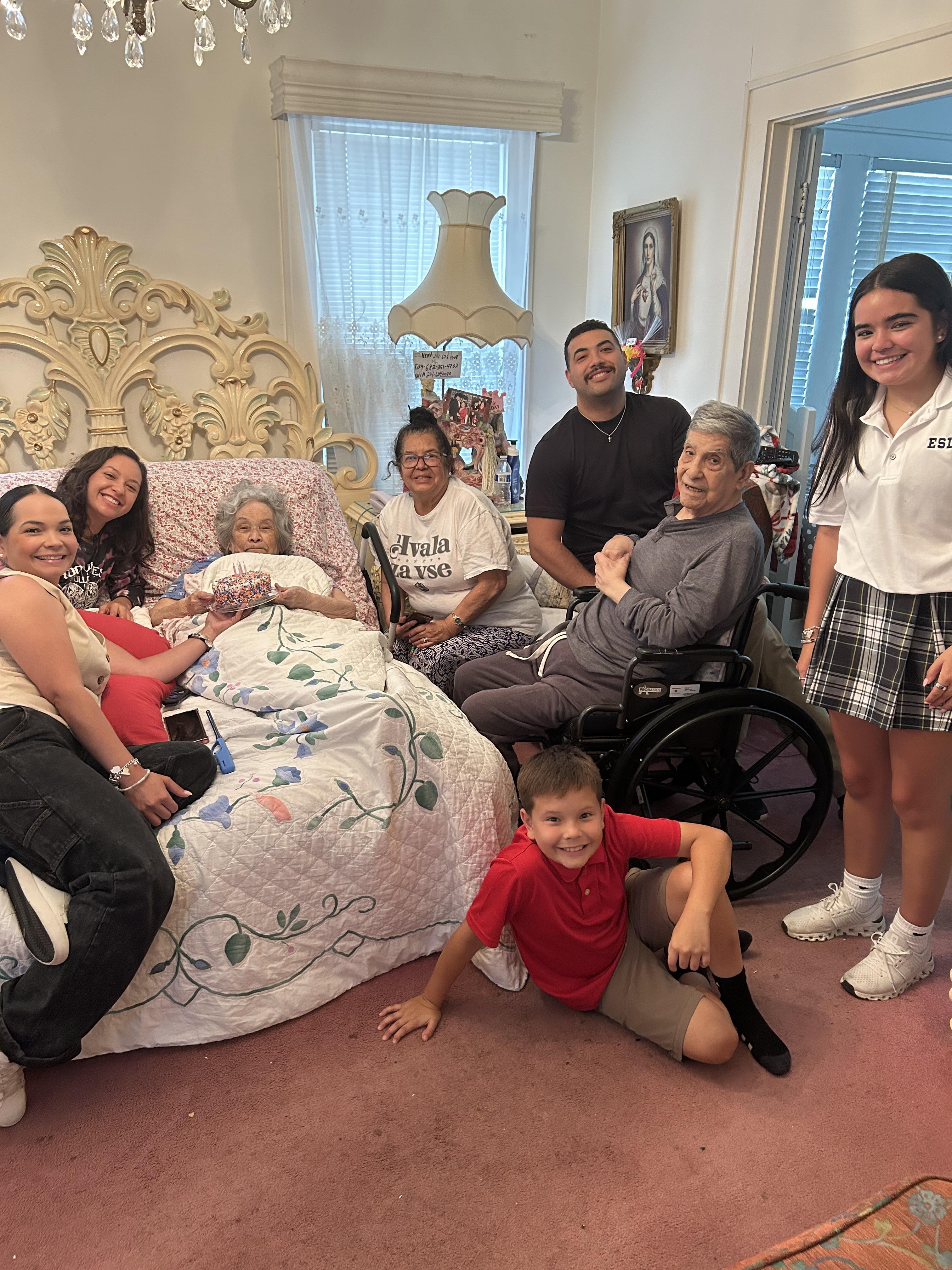 Family gathers in a cozy living room, sharing laughter and quality time with an elder.