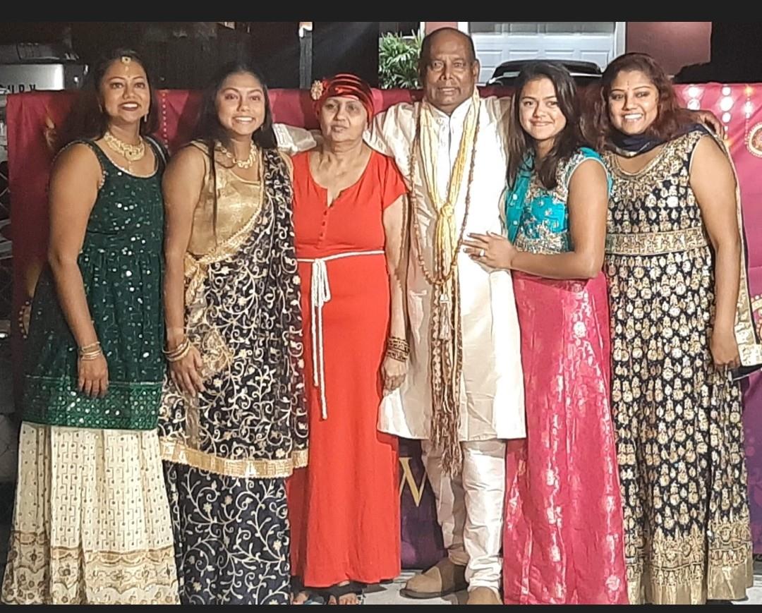 A joyful family gathering in traditional attire celebrating a cultural event.