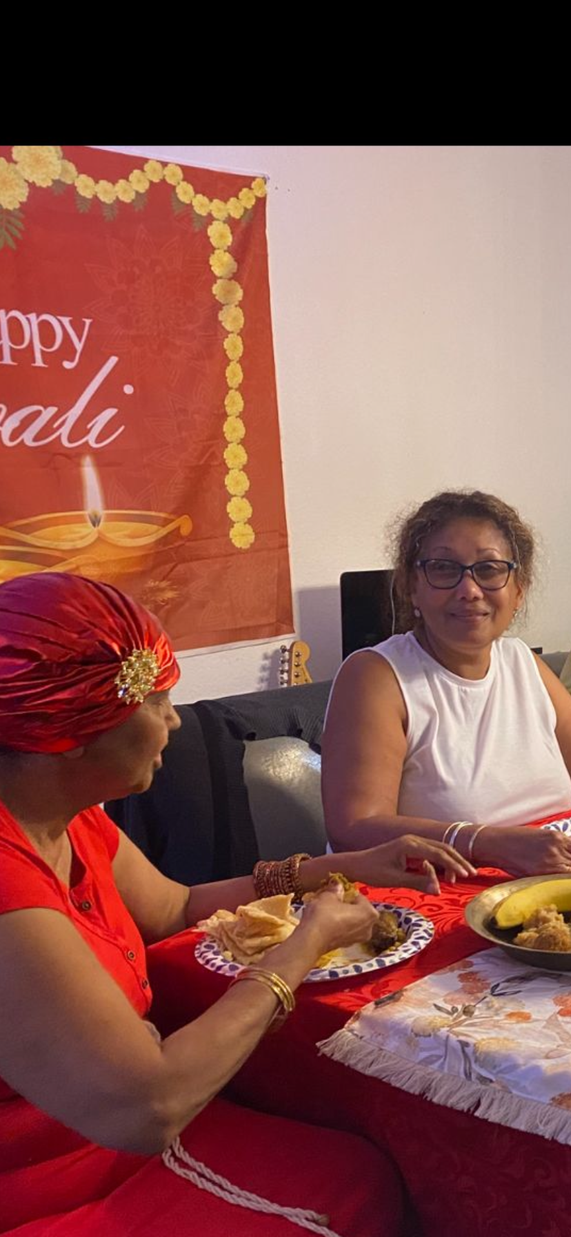 Friends celebrate Diwali in traditional attire, enjoying warm conversations together.