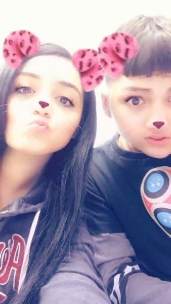 Friends share a joyful moment with playful expressions and filters in a relaxed atmosphere.