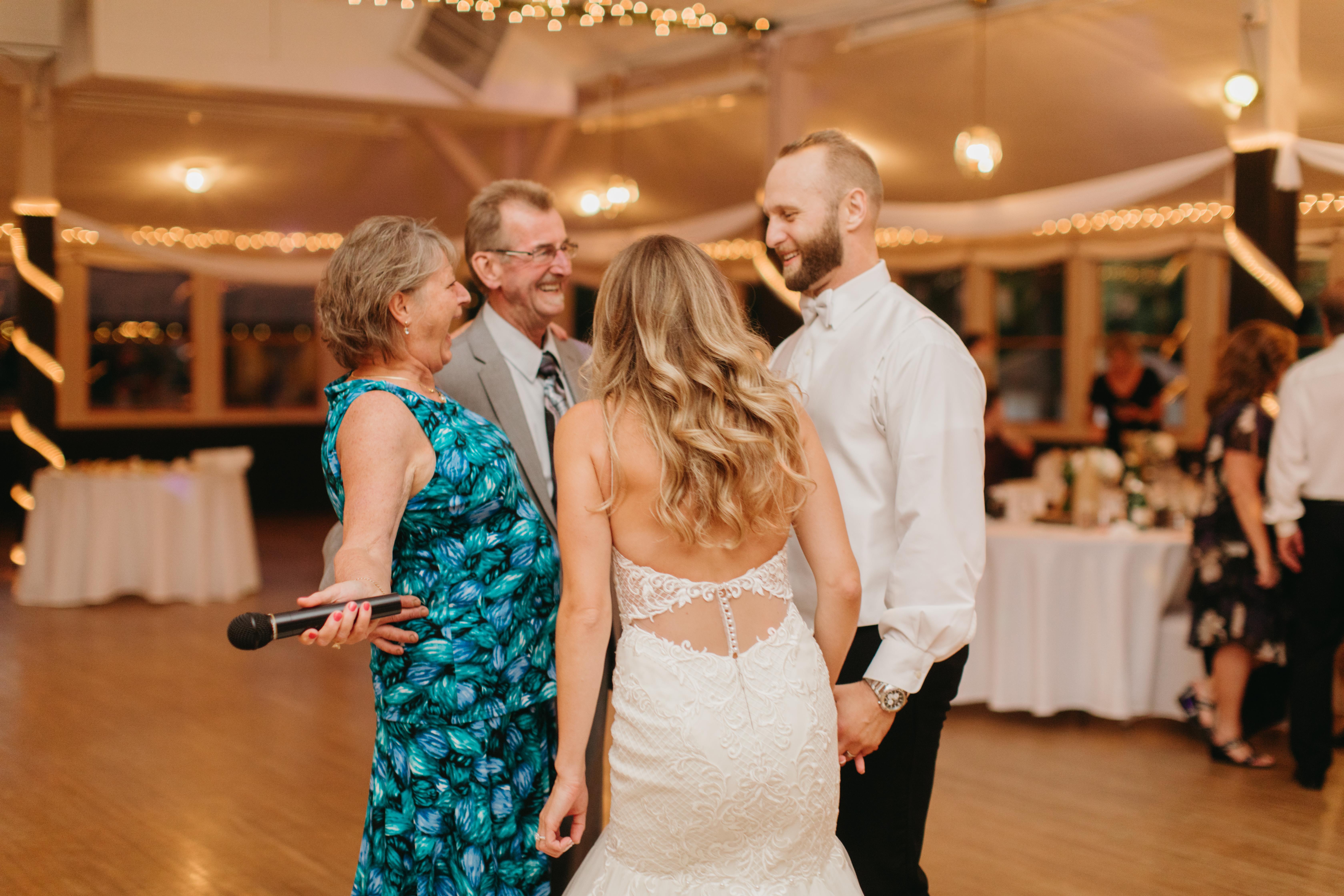 Guests share laughter and smiles during a joyful wedding celebration.