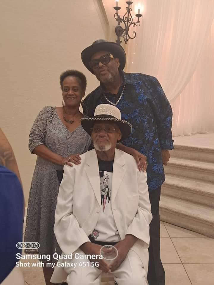 Three friends share a joyful moment, dressed stylishly and posing for a memorable photo.