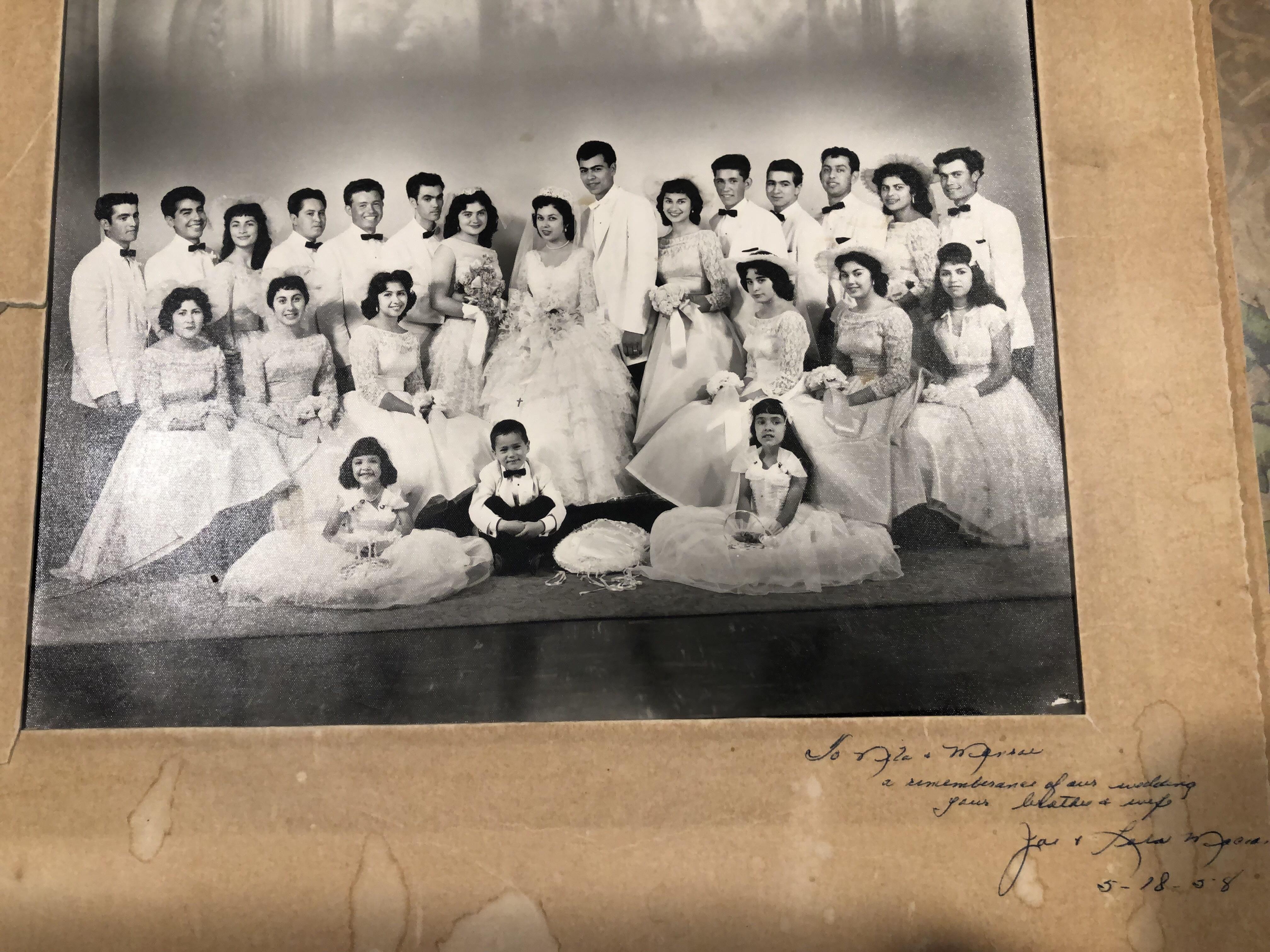 Young men and women in formal attire gathered for a celebration in an elegant indoor environment.