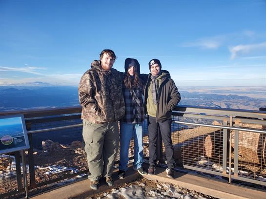 A group of people standing on a ledge