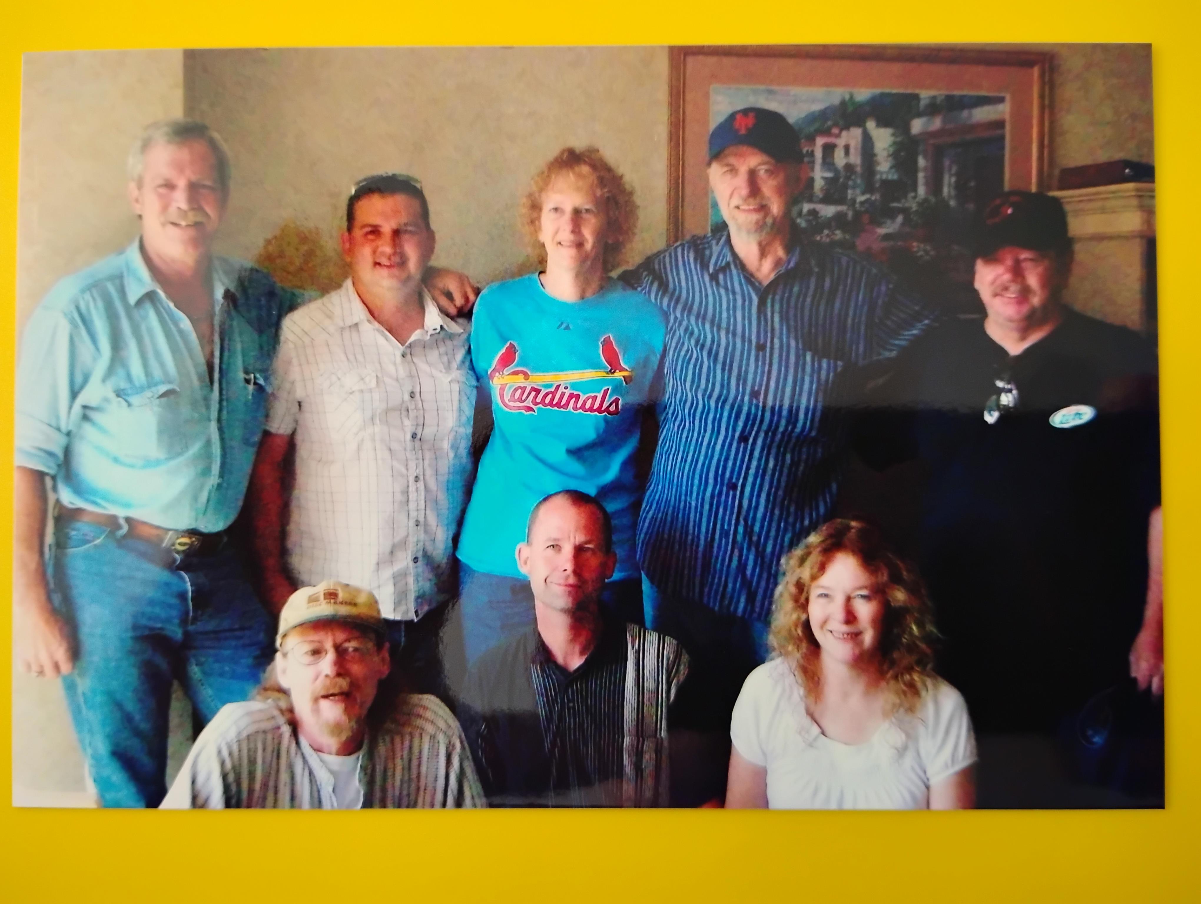 Friends gather for a heartfelt reunion, smiling and enjoying each other's company in a cozy setting.