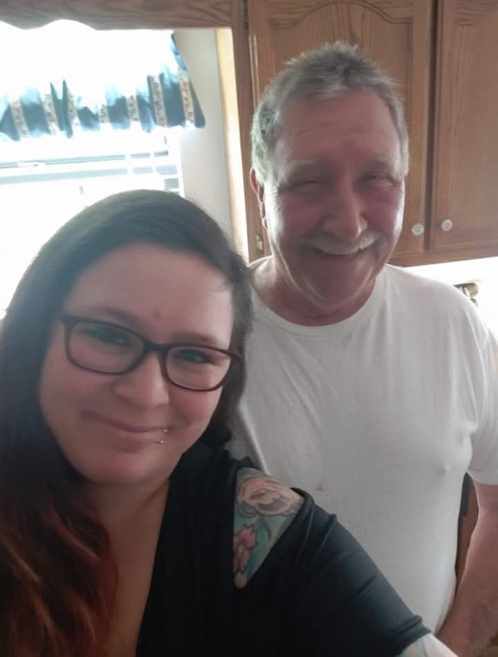Friends enjoy a cheerful moment while taking a selfie in a cozy kitchen setting.