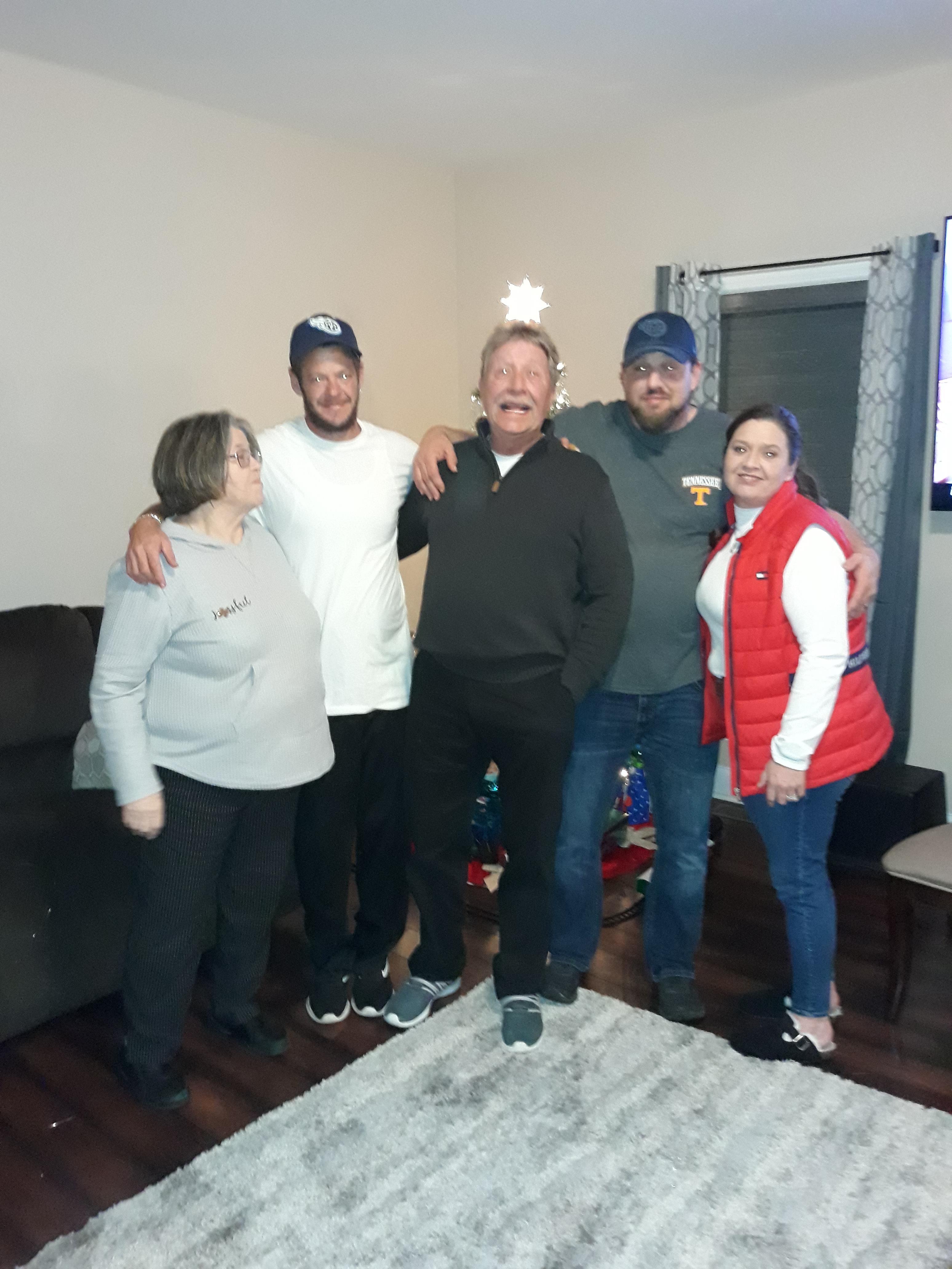 Family enjoys each other's company in a cozy living room for a joyful winter holiday.