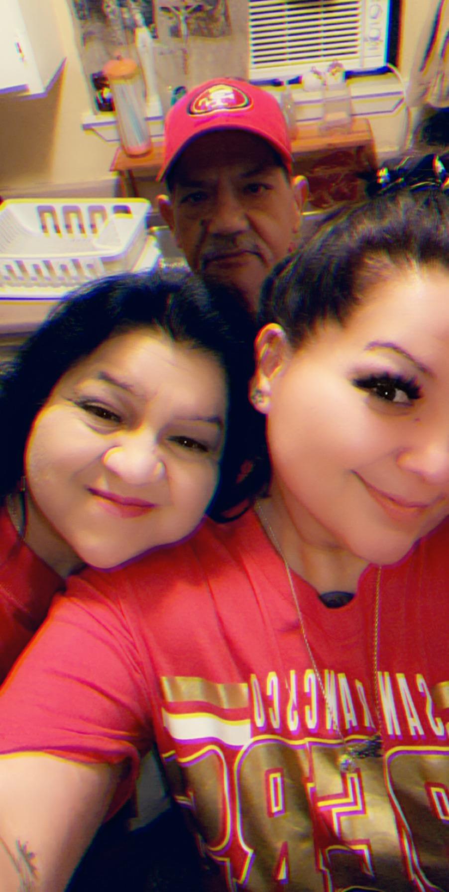 Two women smile warmly together, showcasing a joyful family connection in a casual atmosphere.