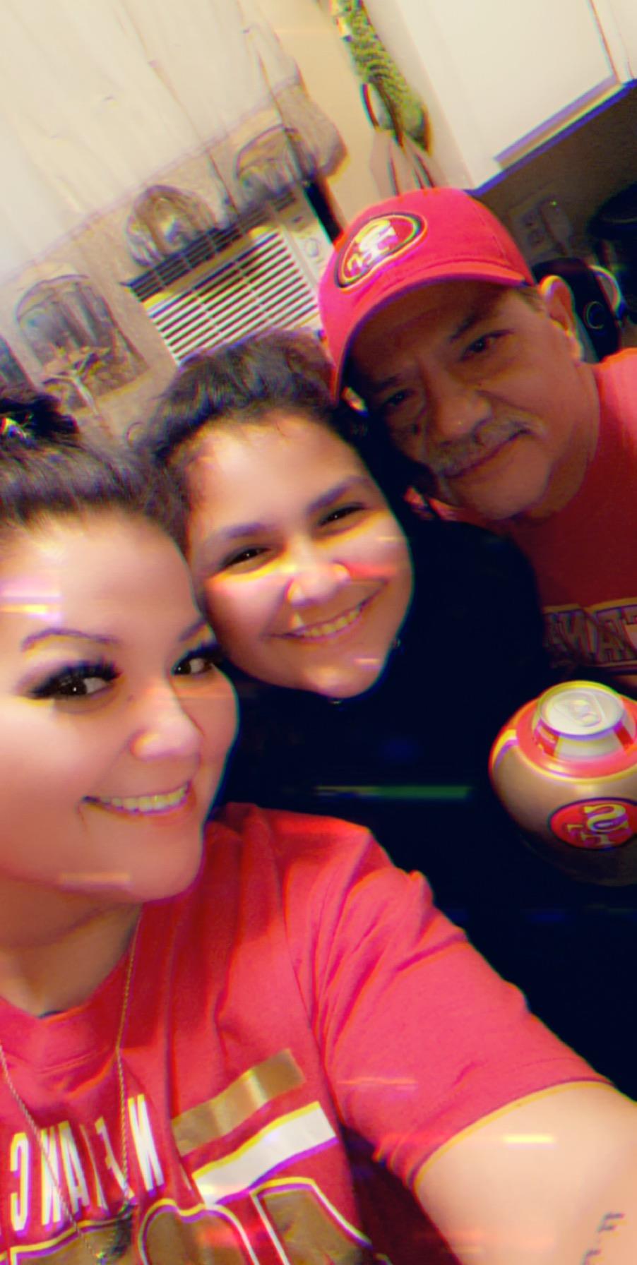 A group of three family members enjoying a cheerful moment together, showcasing their happiness.